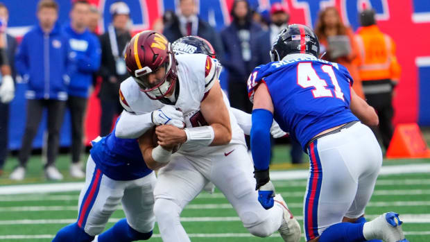 Oct 22, 2023; East Rutherford, New Jersey, USA; Washington Commanders quarterback Sam Howell (14) runs the ball against the New Giants in the second half at MetLife Stadium.